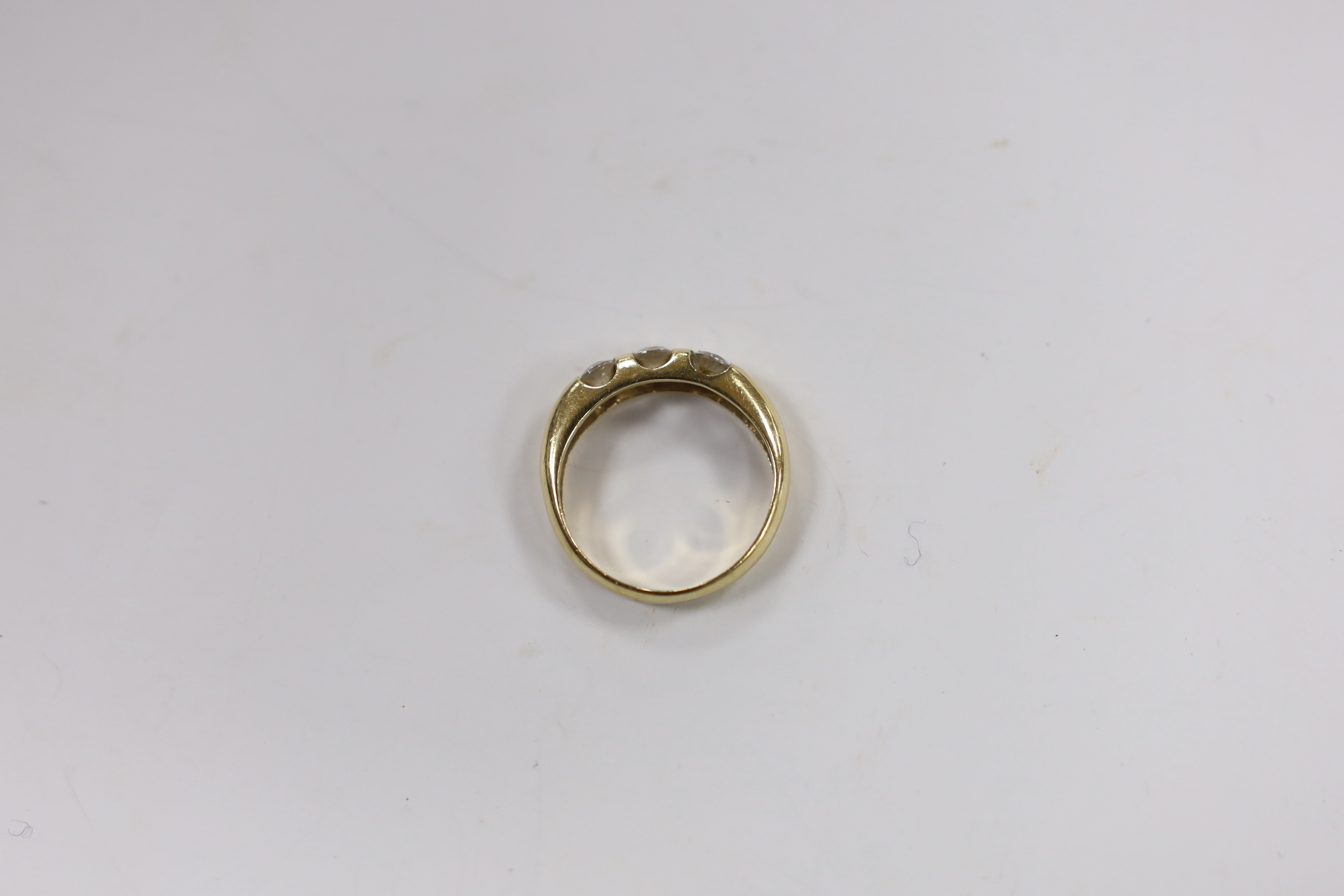 A yellow metal and three stone simulated diamond set ring, size K, gross weight, 2.7 grams.